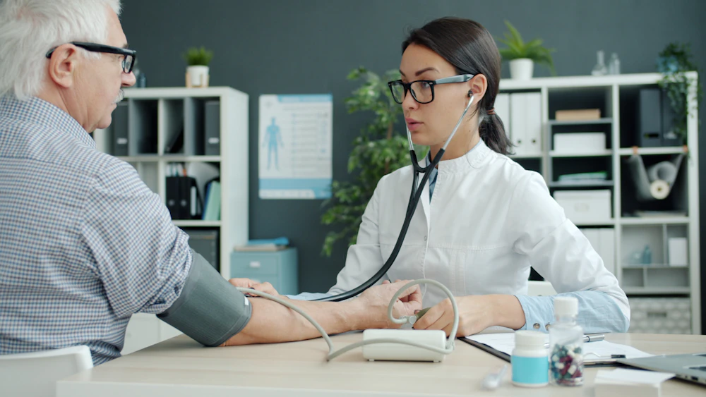 Doctor checking a patient's blood pressure