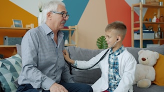 Boy in doctor's coat listens to grandfather's chest