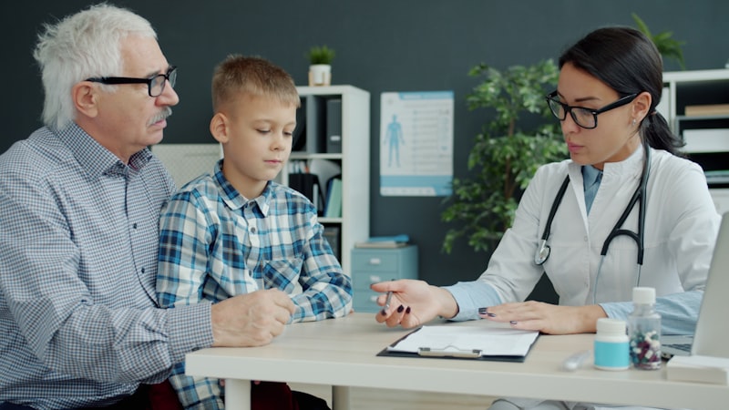 Dr. Elena Marsh talking a grandfather and grandson through a care plan at Clearview Family Medicine