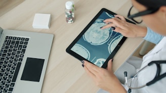 Doctor examining brain scan on tablet at desk.