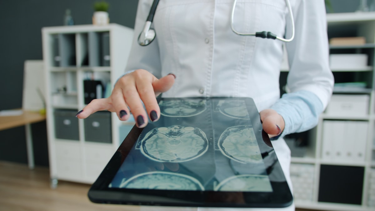 Nurse reviewing health information on a tablet, one of the best AI tools for school nurses