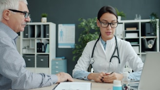 Doctor consulting with an elderly patient in an office.