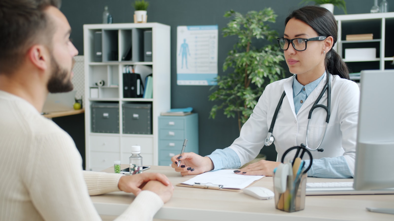 Doctor consulting with a patient about care options at a desk