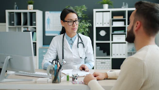 Doctor consults with patient in medical office.