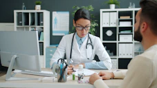 Doctor consulting with patient at desk