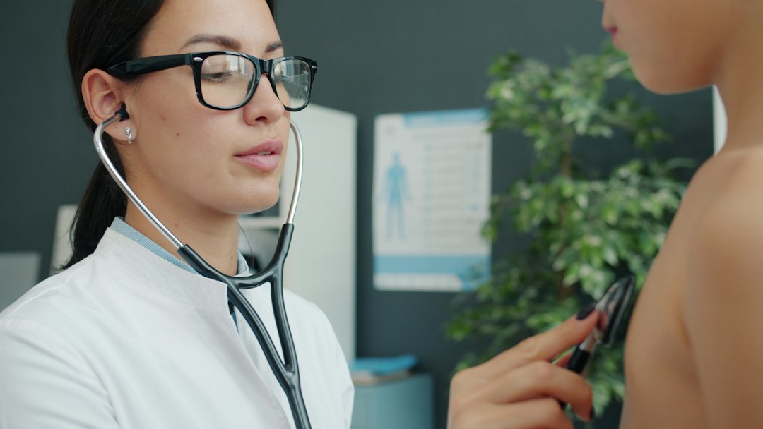 Doctor examines child with stethoscope in clinic
