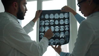 Two doctors examining a brain mri scan together.