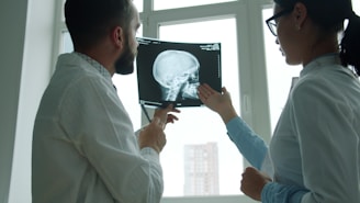 Doctors examine a skull x-ray in a bright room.