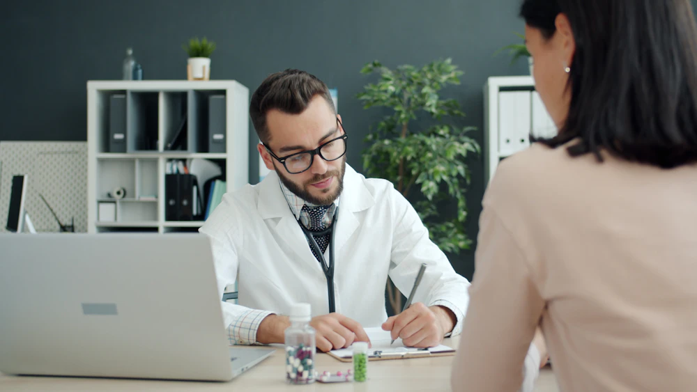 Clinician using ZOC Medical care coordination platform on a laptop