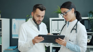 Two doctors looking at a tablet together