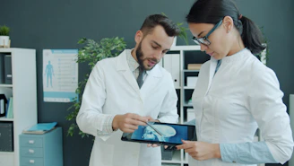 Two doctors looking at a medical scan on tablet