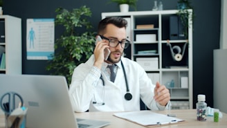 Doctor talking on the phone in his office.