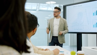 Winnipeg business person presenting data on a large screen to colleagues.