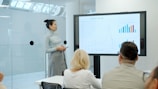 Woman presenting a graph to an audience