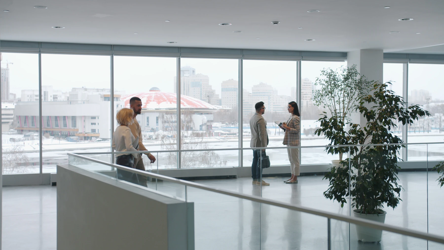 People move through a bright modern office lobby