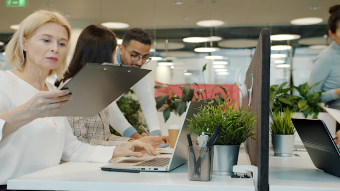 Professionals working with laptops in a modern office