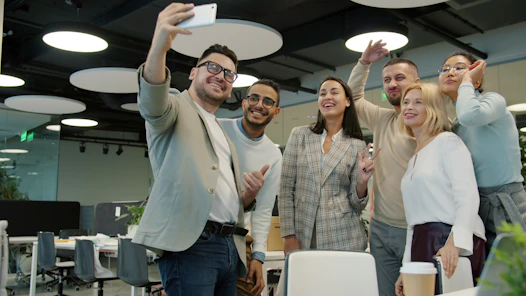 Group of colleagues taking a selfie in the office.