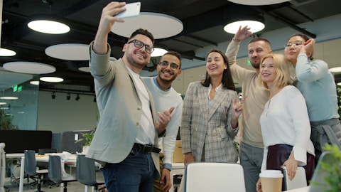 Group of colleagues taking a selfie in the office.