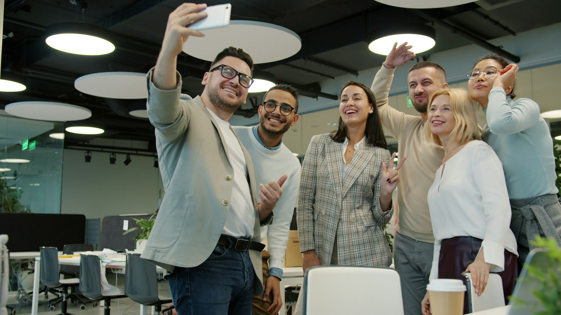 Group of colleagues taking a selfie in the office.