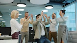 Diverse group of colleagues celebrating success in office