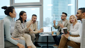 Diverse group of people in a modern office meeting.