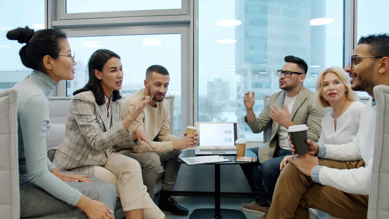 Diverse executive leadership team discussing business strategy in a modern office