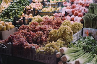 Fresh grapes, fruits, and vegetables at a market.