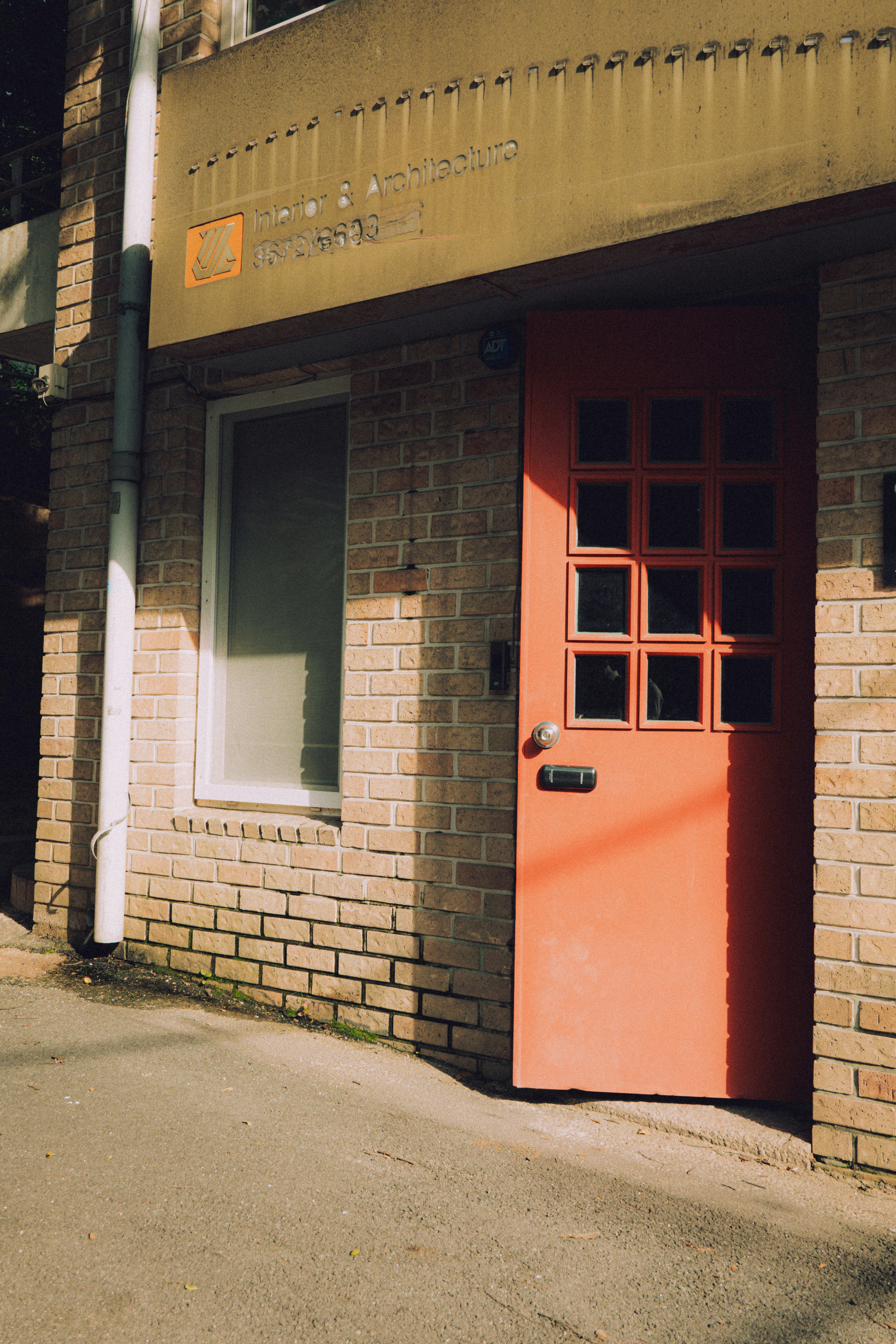 Red door with glass panes on brick building