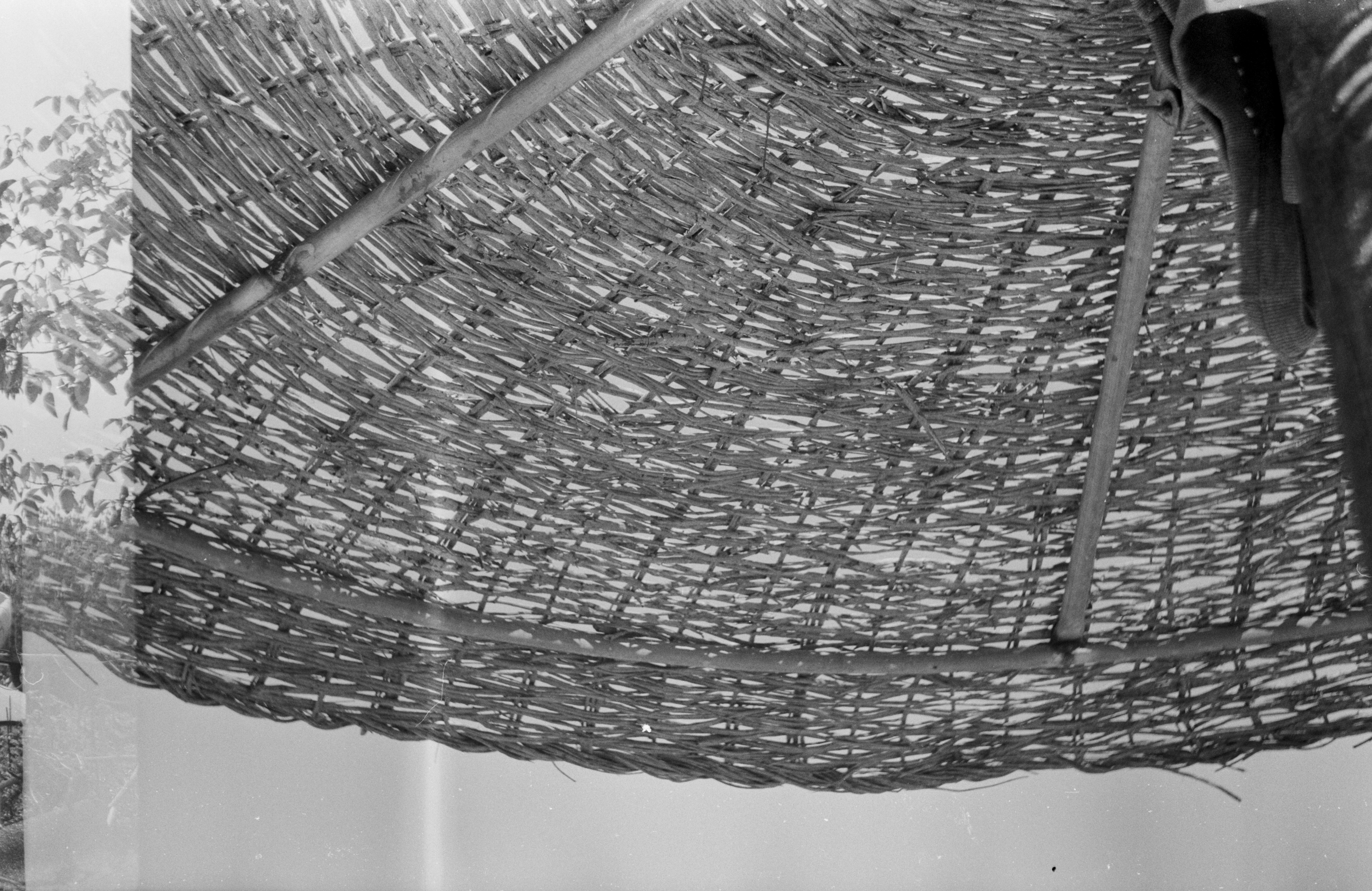 Underside of a woven straw beach umbrella