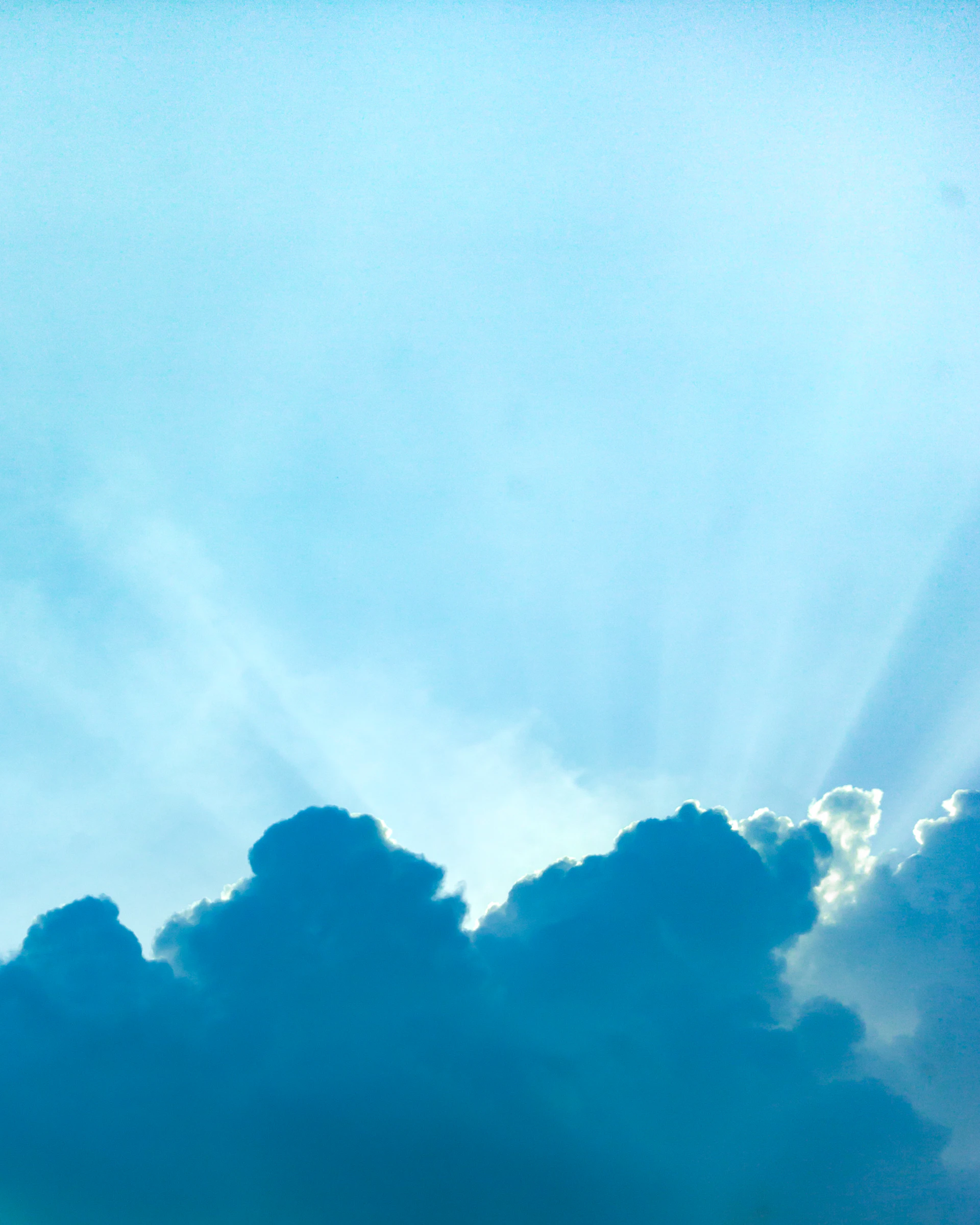Sun rays bursting through dark clouds