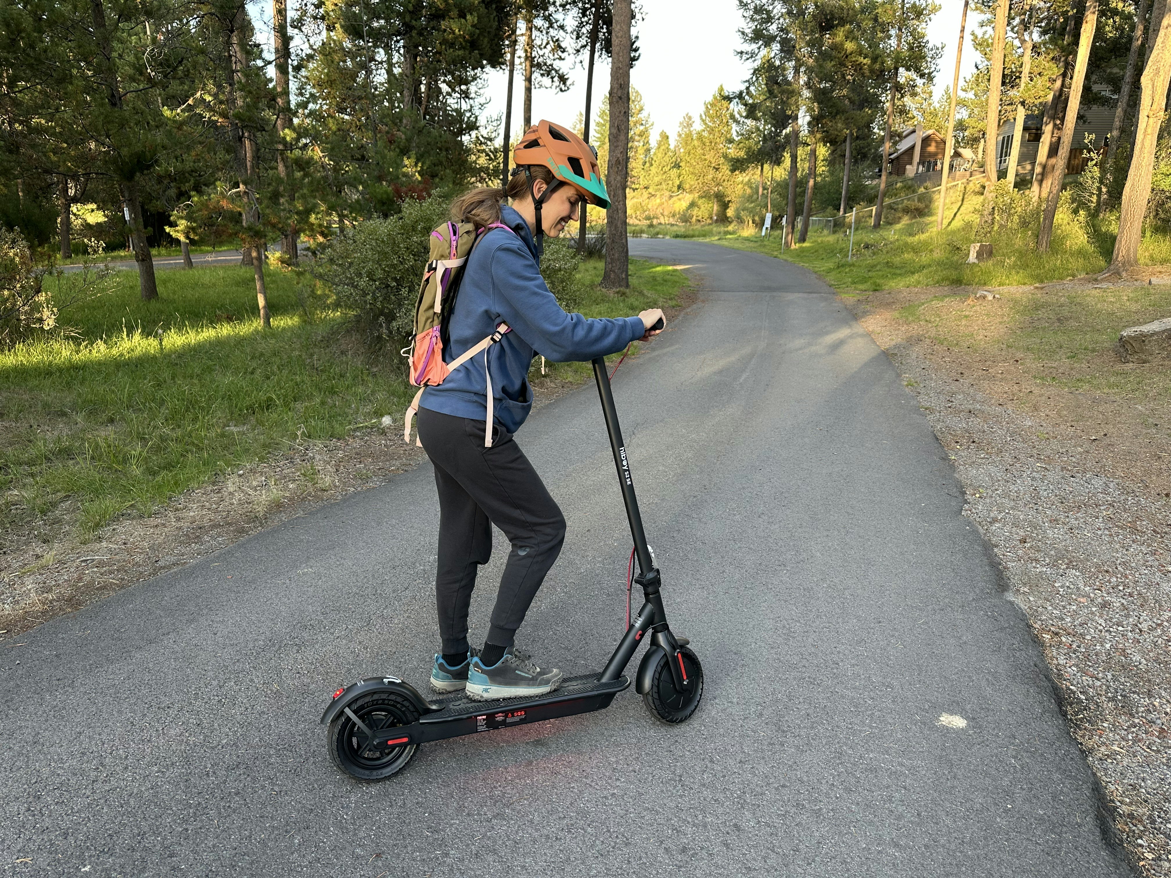 Person riding an electric scooter on a paved path