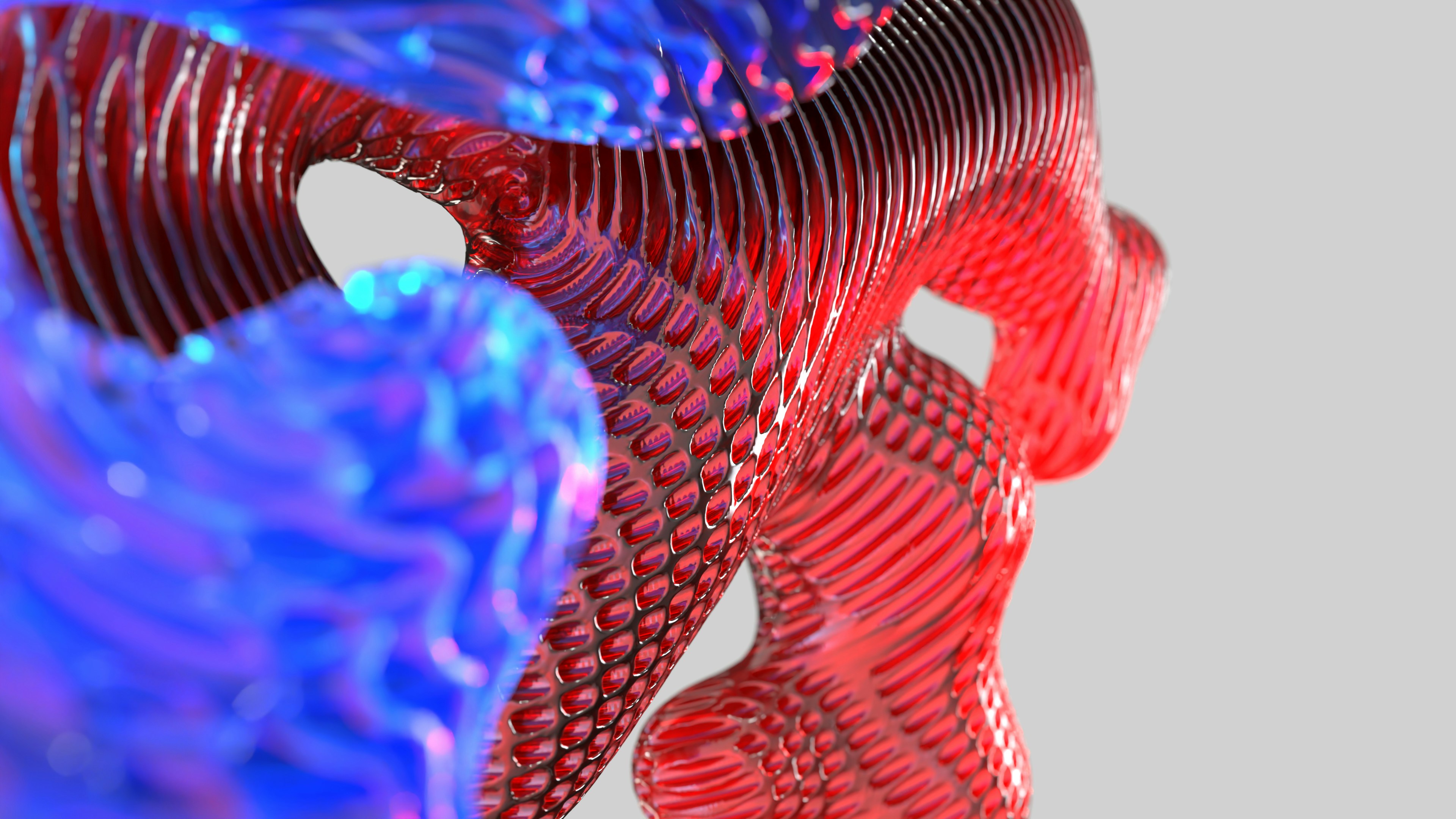 Formas abstractas de remolinos rojos y azules con superficies texturizadas.