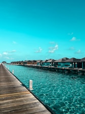 Overwater bungalows line a clear turquoise ocean