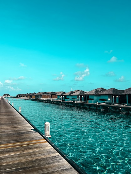 Overwater bungalows line a clear turquoise ocean