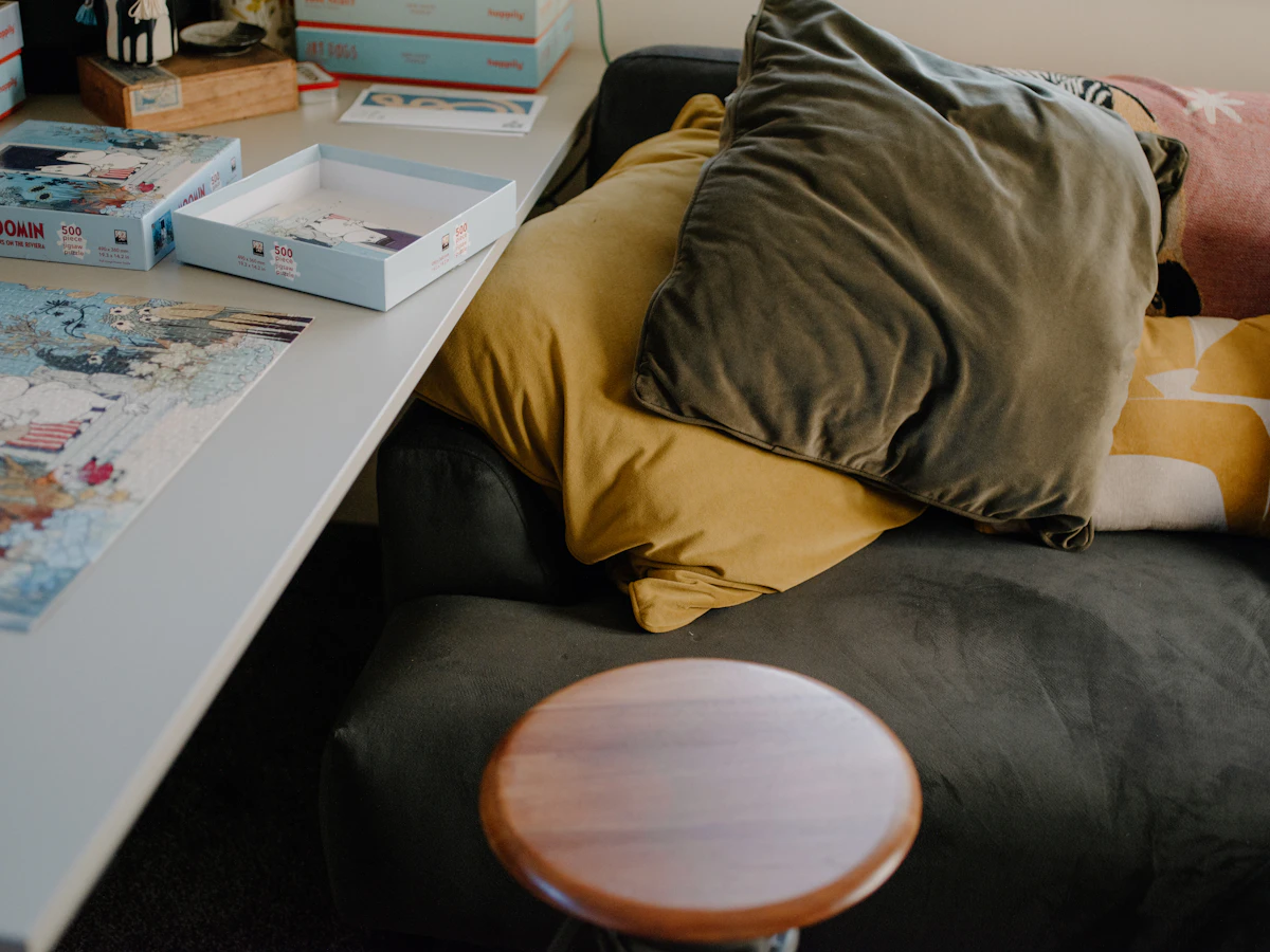 Mixed-size cushions layering a small lounge sofa