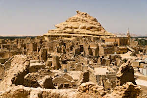 Ancient mud-brick village ruins under a clear sky