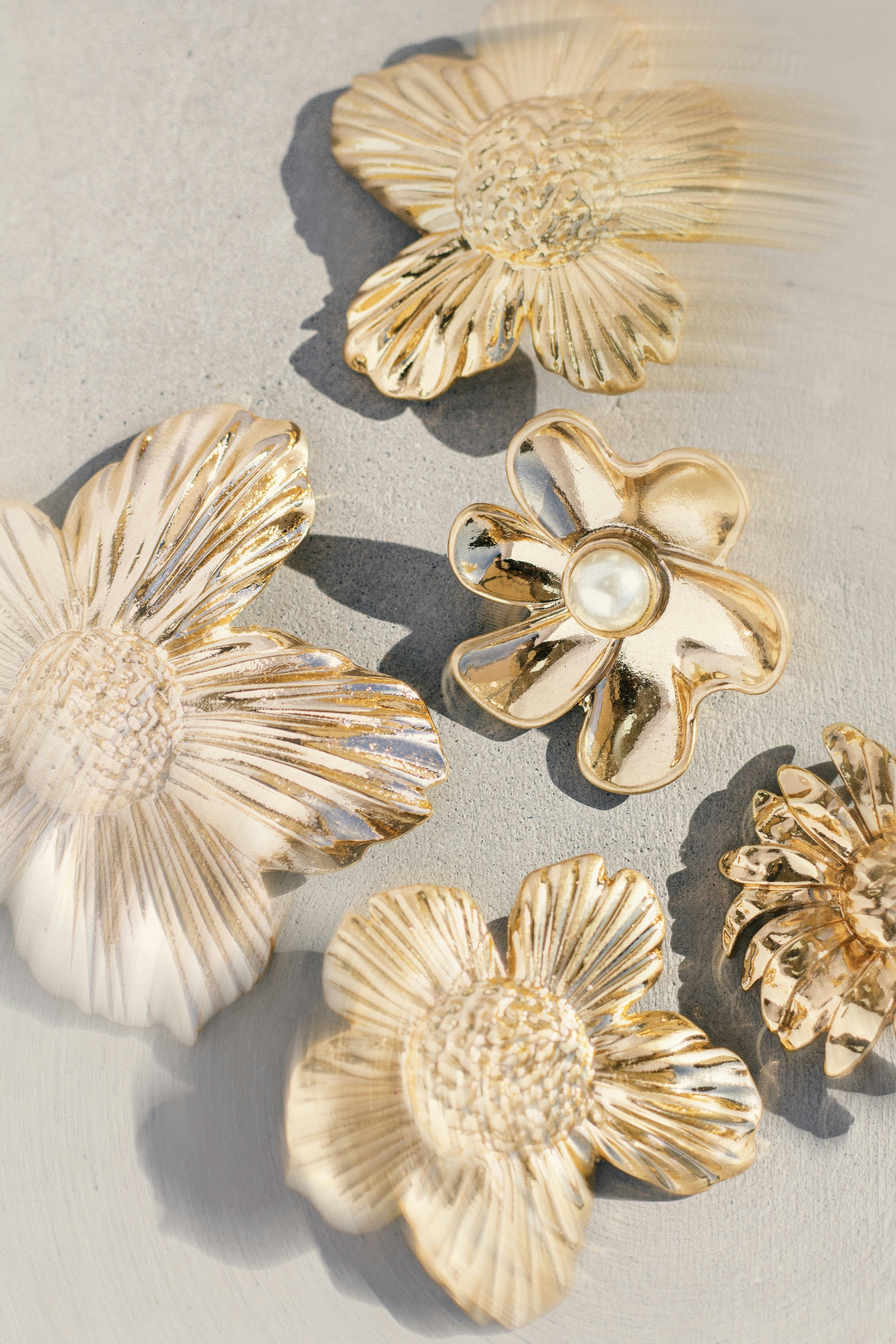 Several golden decorative flowers with pearl accents.