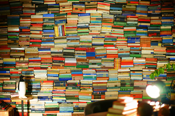 A wall covered with many colorful books
