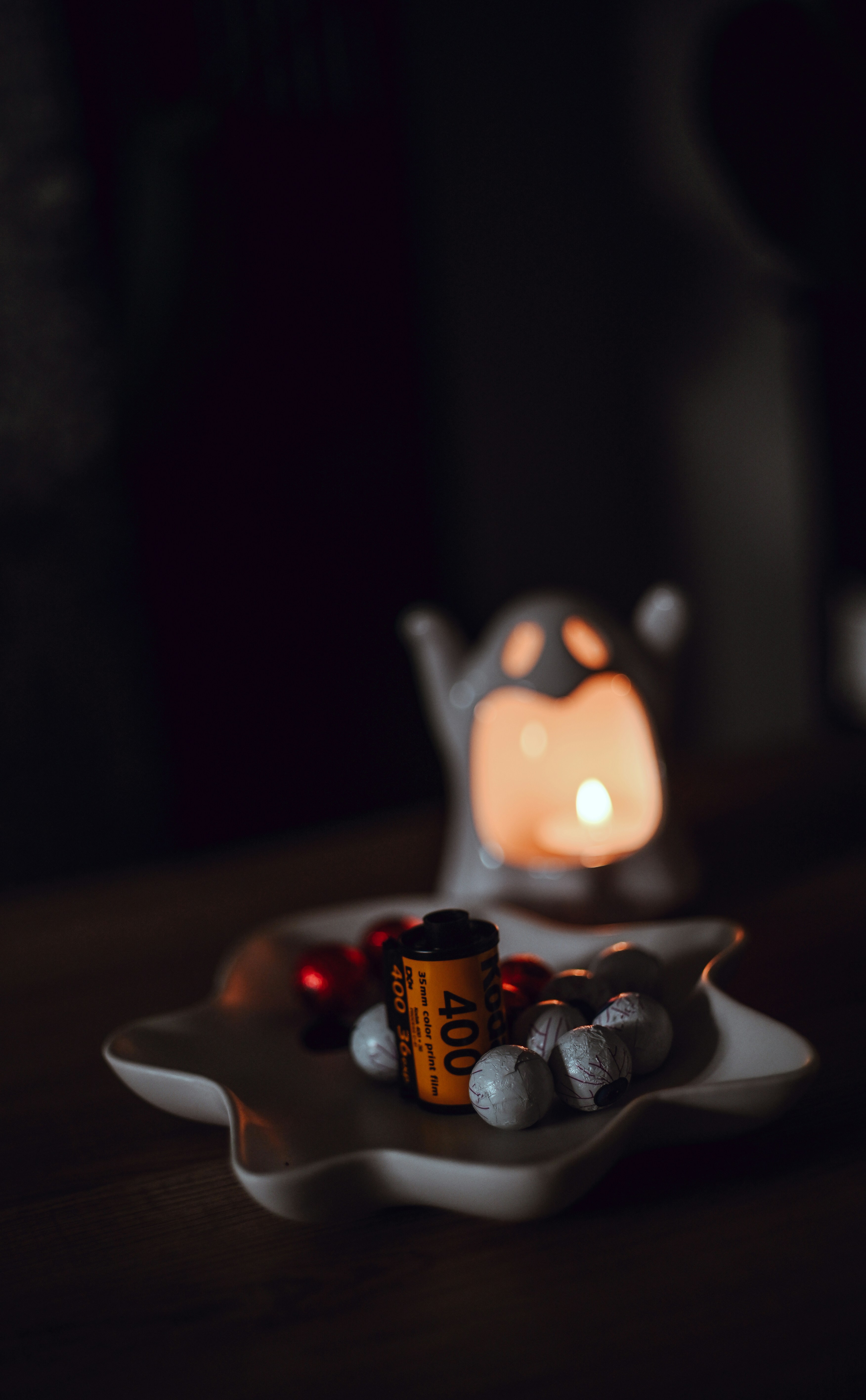 Film roll with ornaments and candle in ghost holder