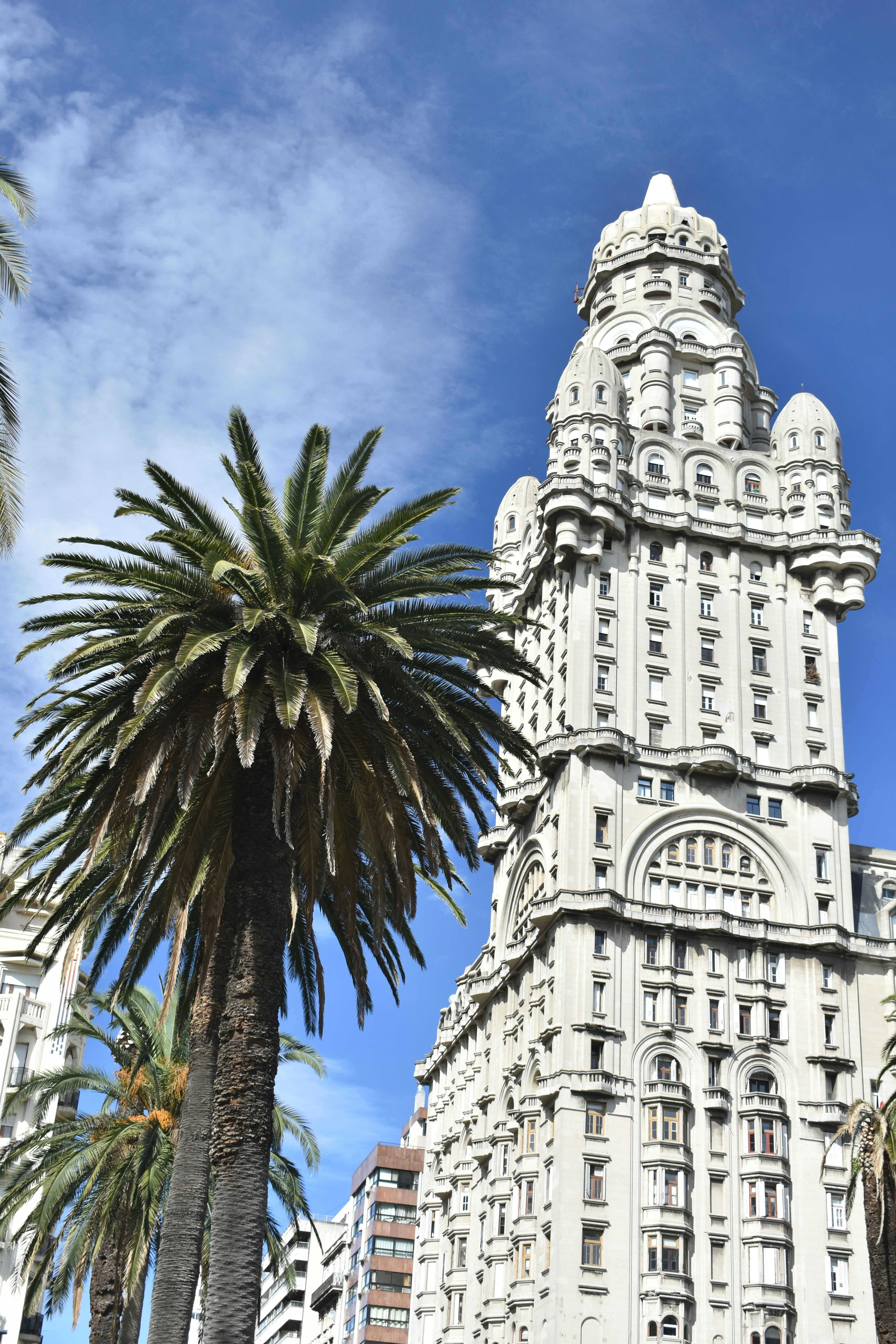 Ornate building with palm trees under blue sky