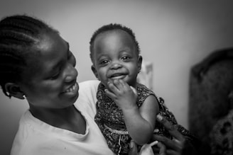 Mother holding a smiling baby in her arms