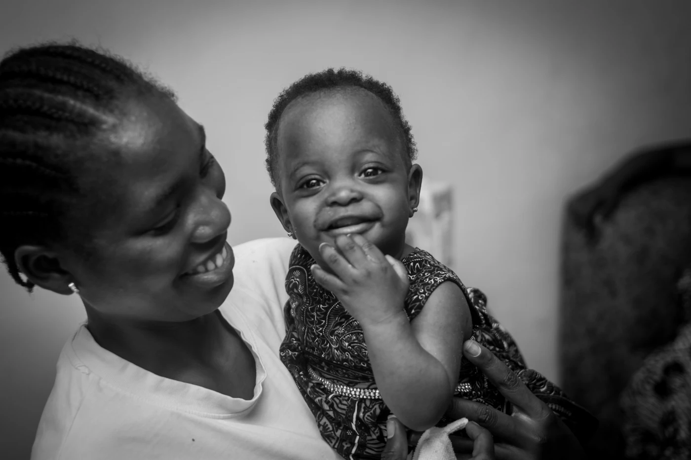 A mother at home holding her smiling baby