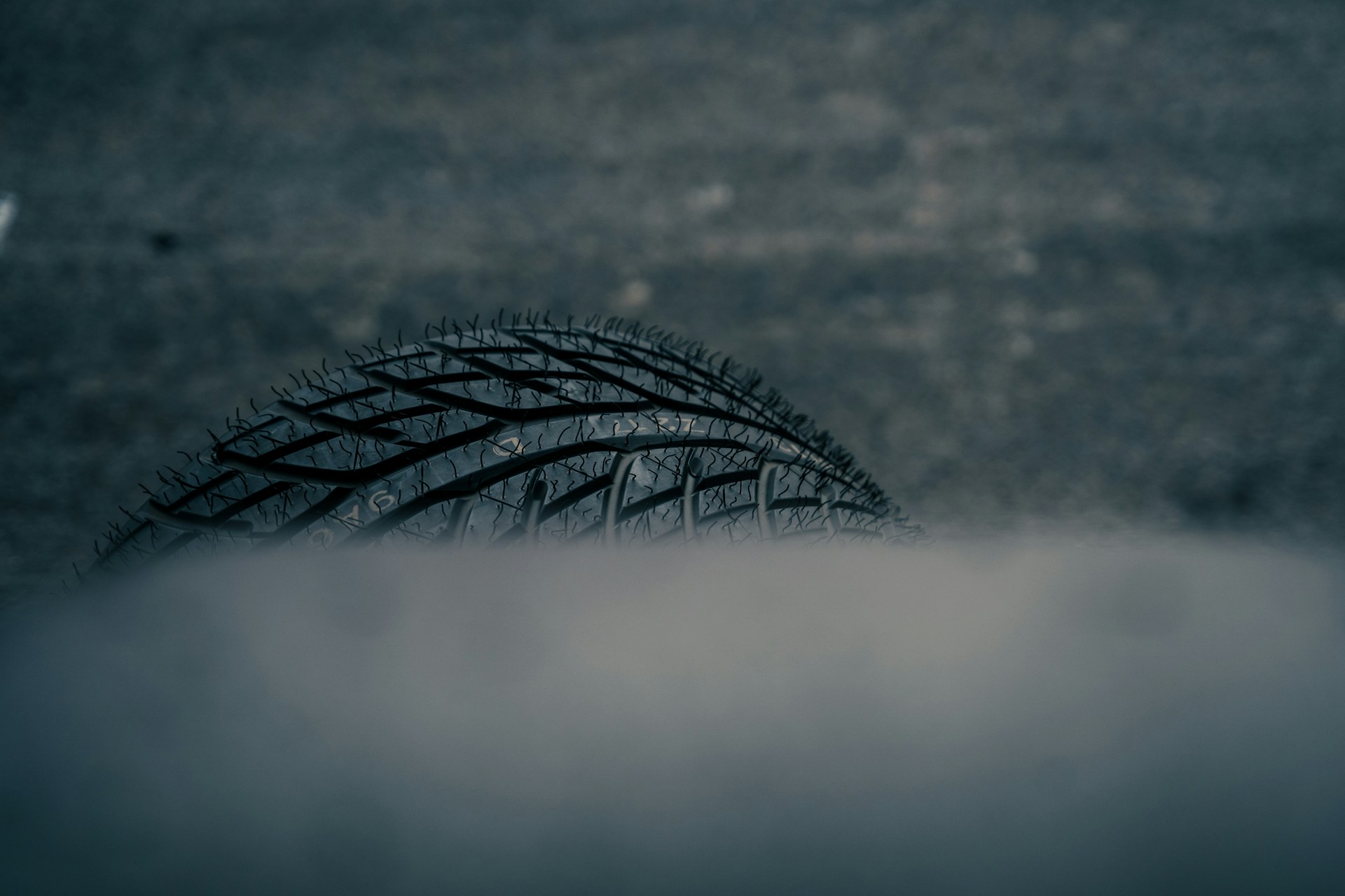 Close-up of a car tire in smoke