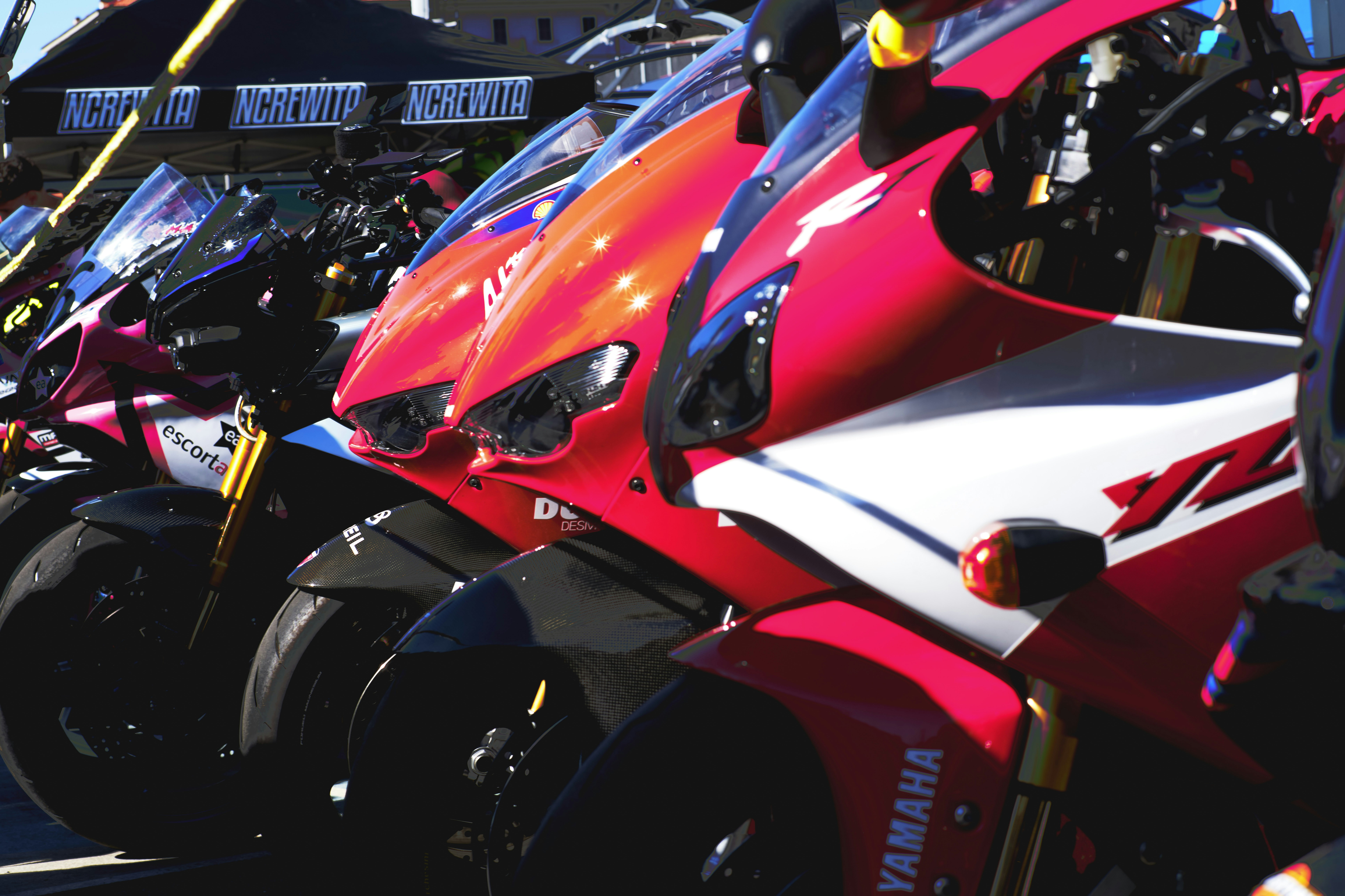 Row of vibrant sport motorcycles parked outdoors