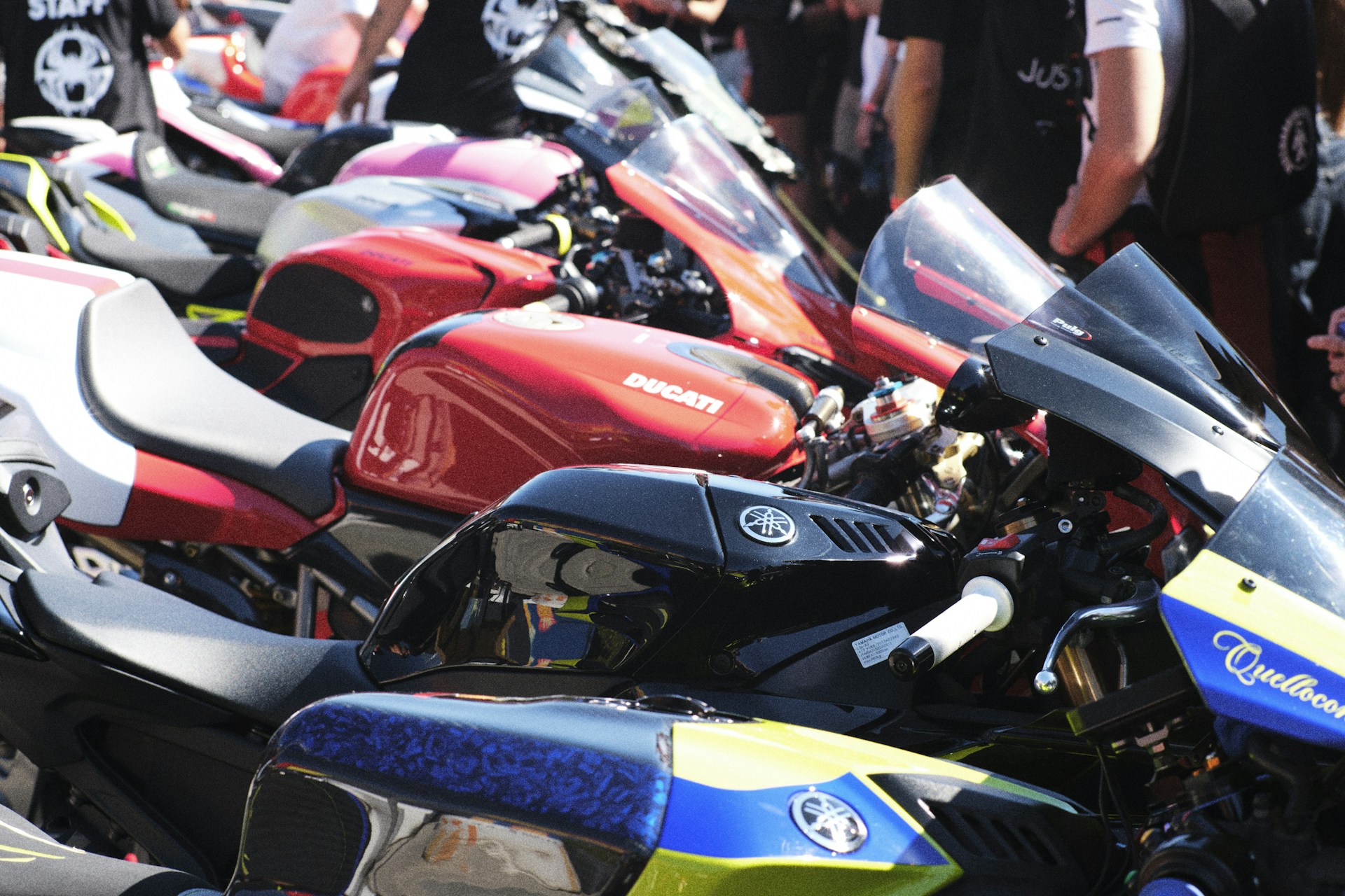 Row of colorful sport motorcycles parked together.