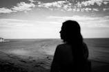 Silhouette of a woman looking at the ocean