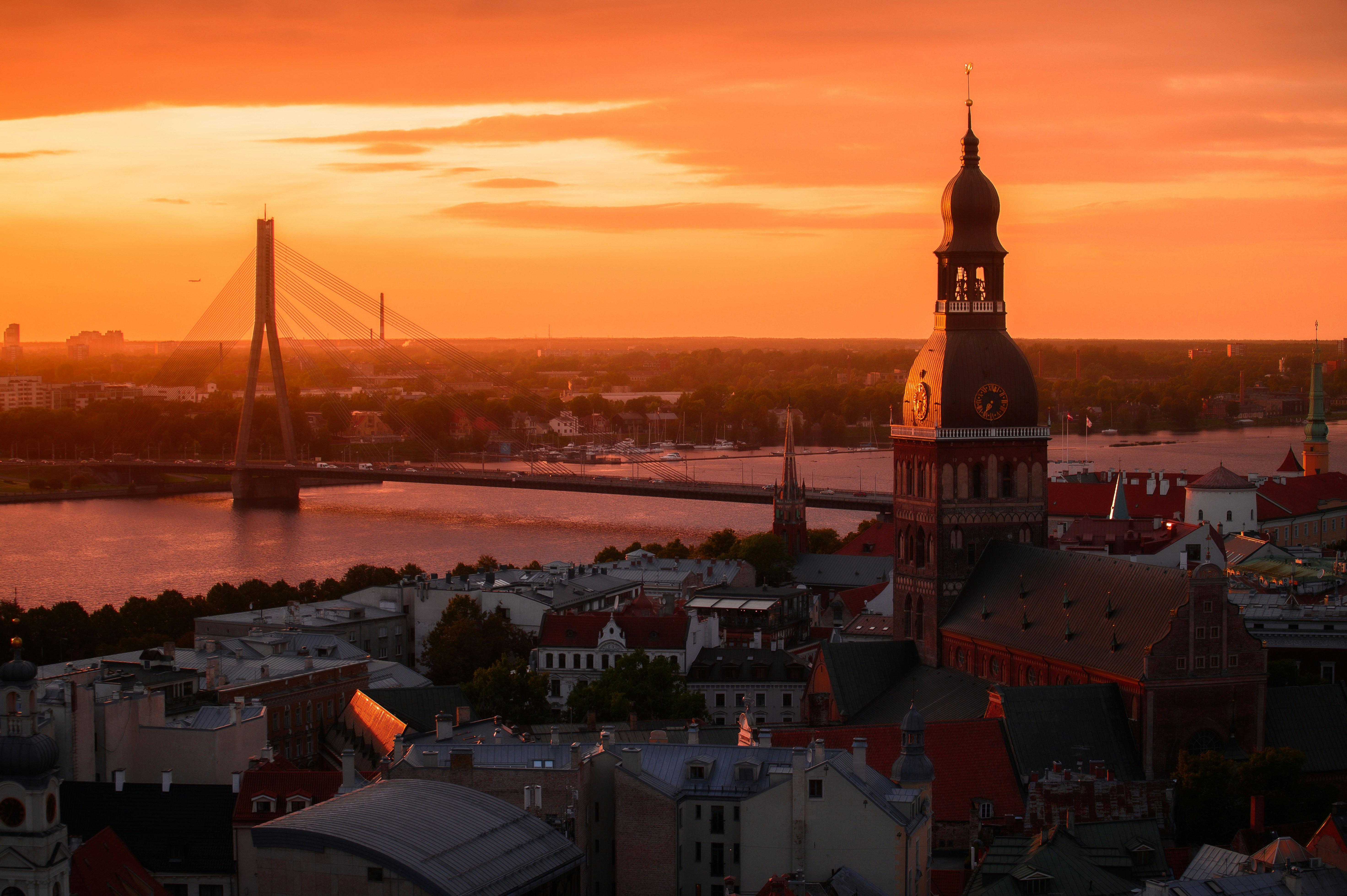 Cityscape with a river and bridge at sunset