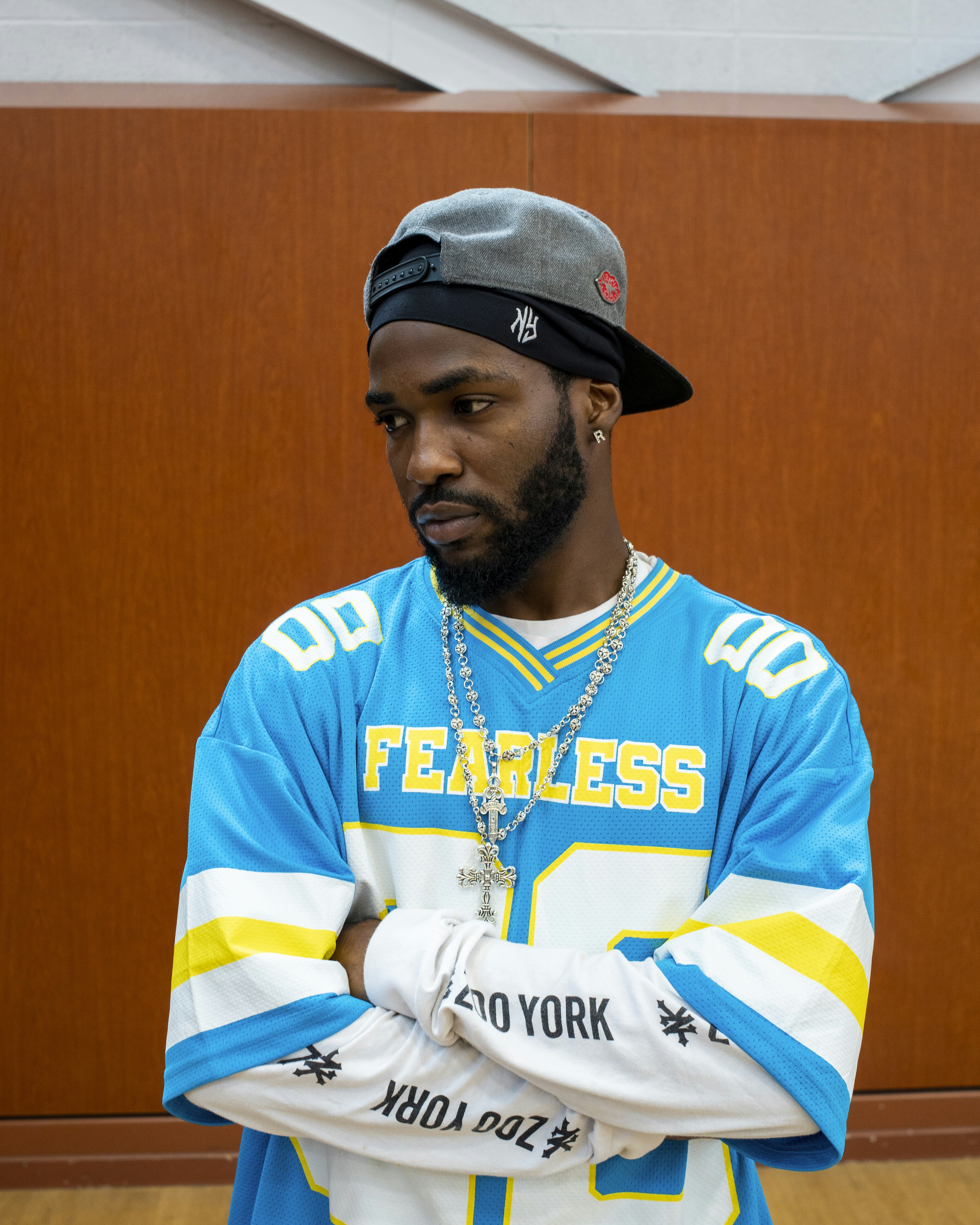 Man in blue jersey with arms crossed