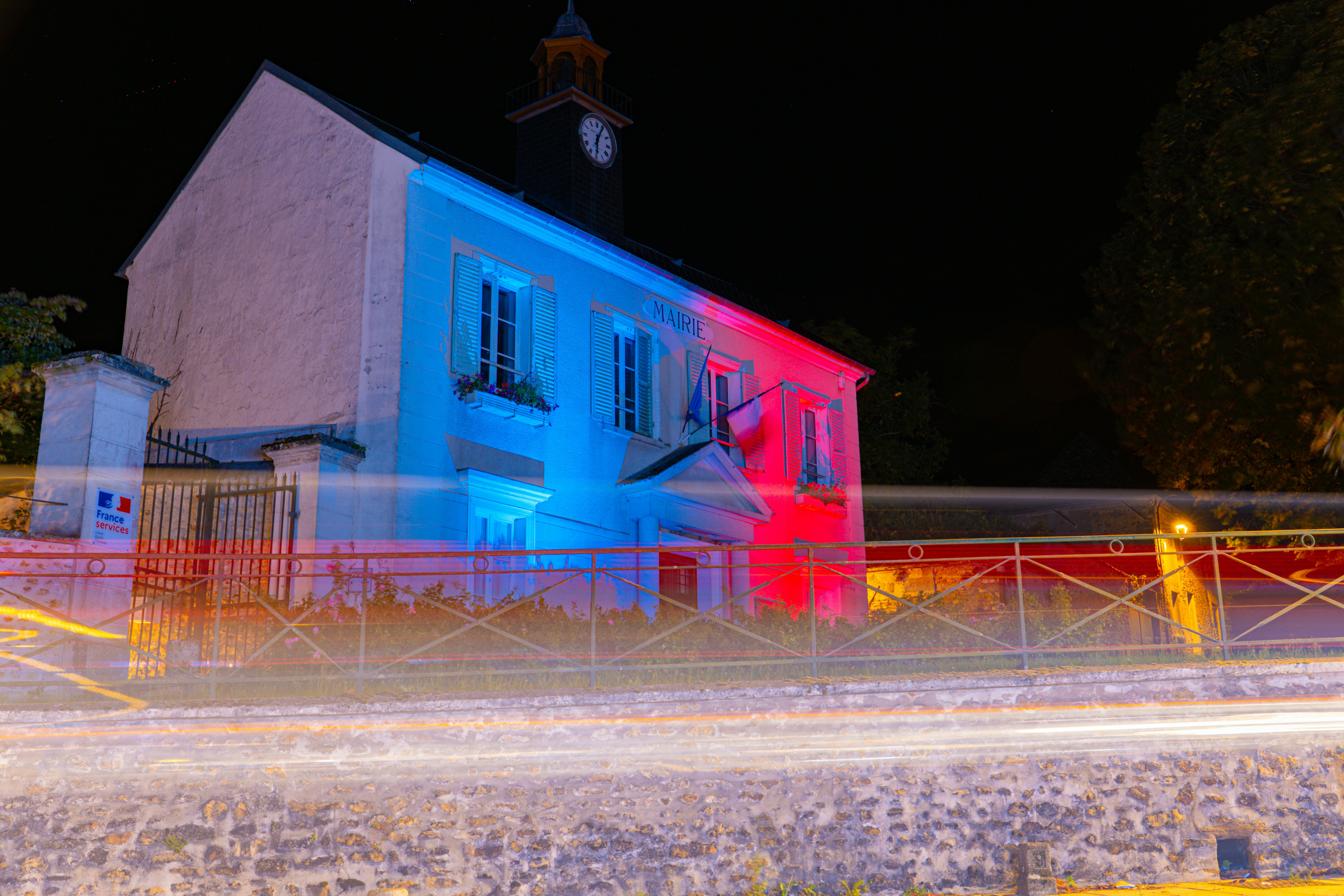 Building illuminated with red and blue lights at night
