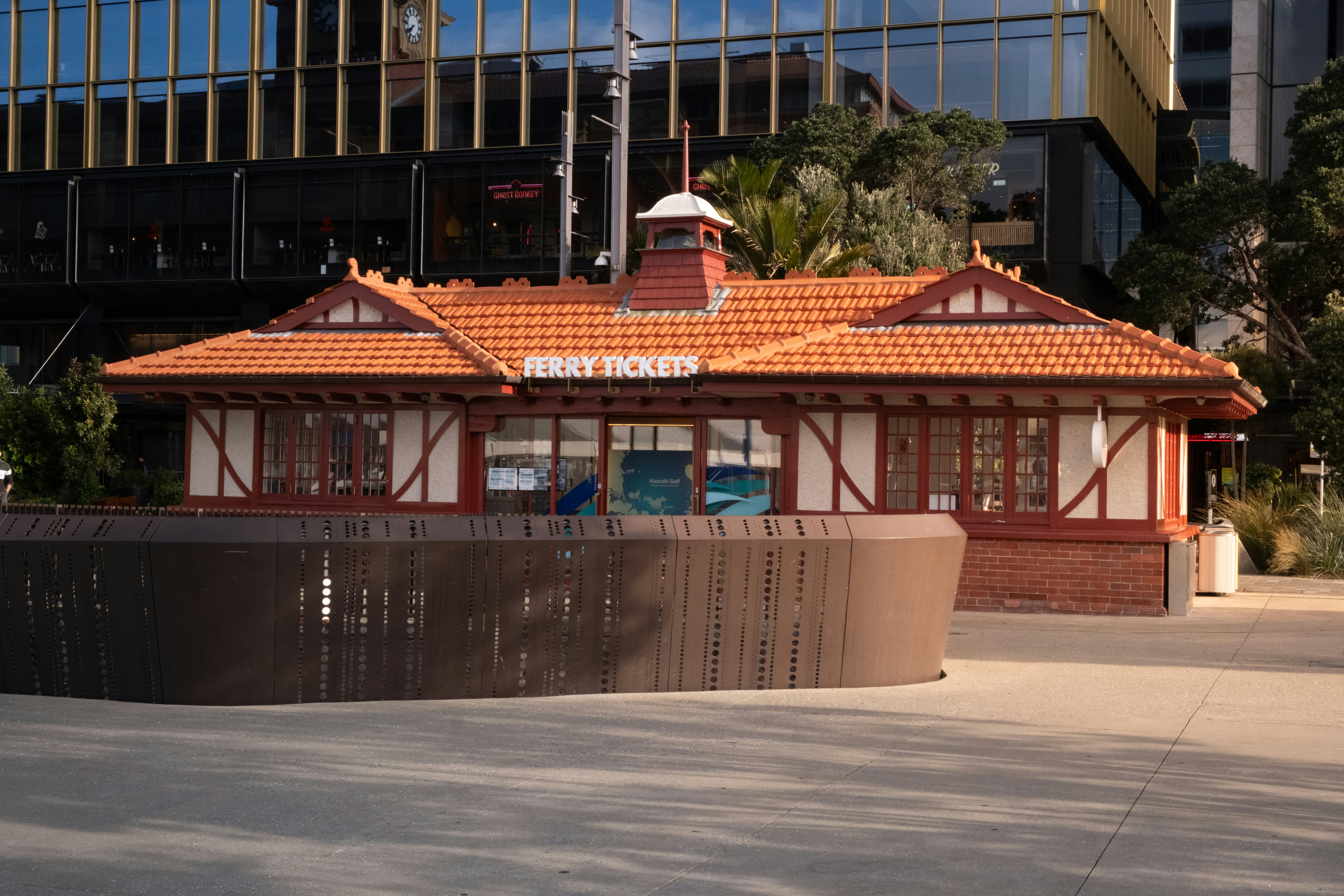 Small heritage building with orange tiled roof and white trim.